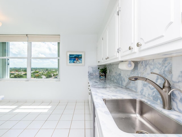 kitchen with sink, decorative backsplash, and white cabinets