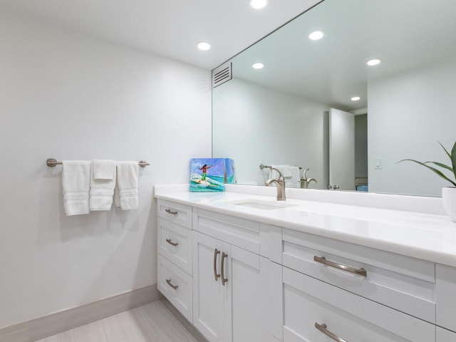 bathroom featuring vanity and wood-type flooring