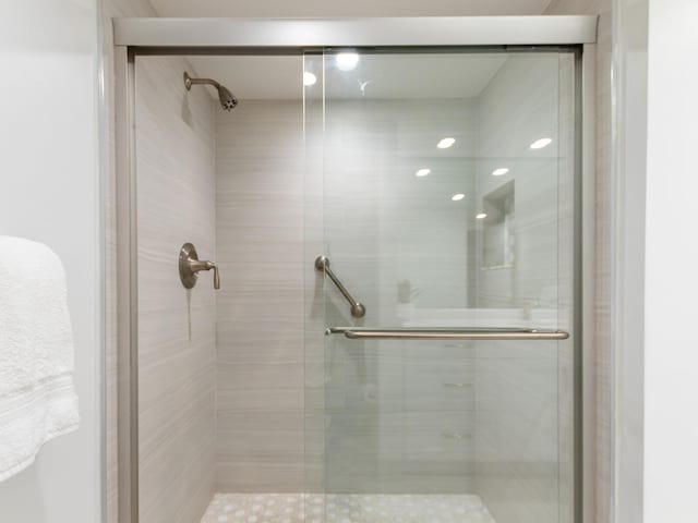 bathroom with a shower with shower door