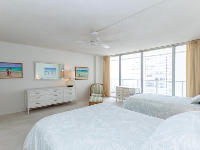 carpeted bedroom featuring ceiling fan, a textured ceiling, and access to outside