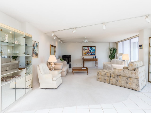 carpeted living room with ceiling fan and track lighting