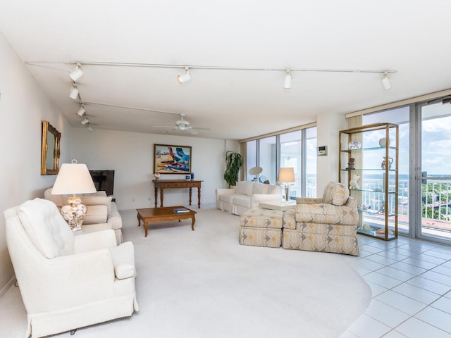 living room with expansive windows, ceiling fan, and light tile patterned floors