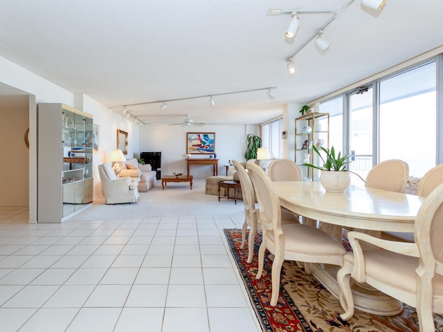 tiled dining space with ceiling fan