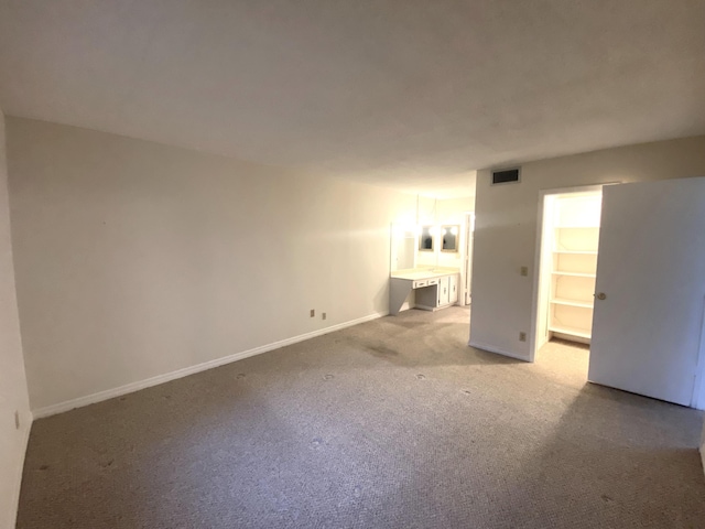 empty room with light colored carpet