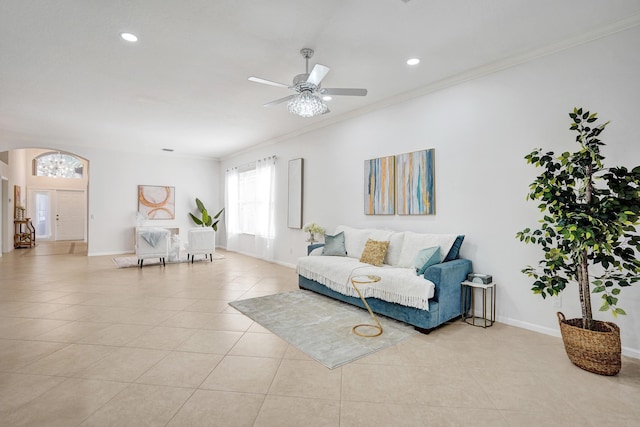 tiled living room featuring crown molding and ceiling fan