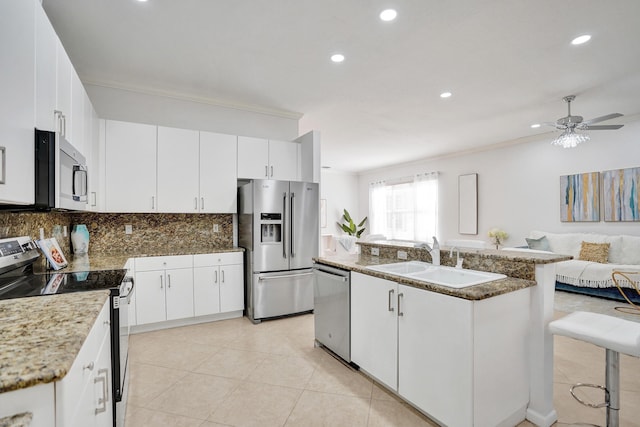 kitchen with stainless steel appliances, white cabinetry, and sink