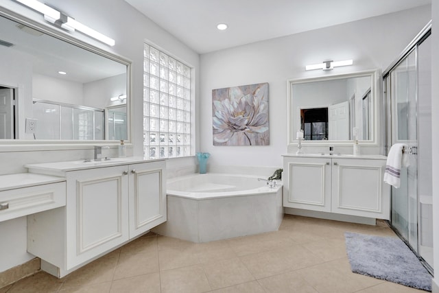 bathroom with tile patterned flooring, vanity, and shower with separate bathtub