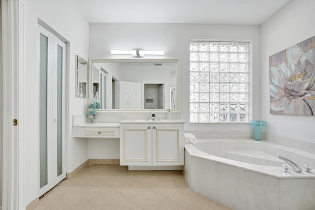 bathroom featuring vanity, a bathing tub, and tile patterned flooring