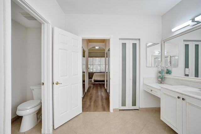 bathroom featuring tile patterned flooring, vanity, and toilet