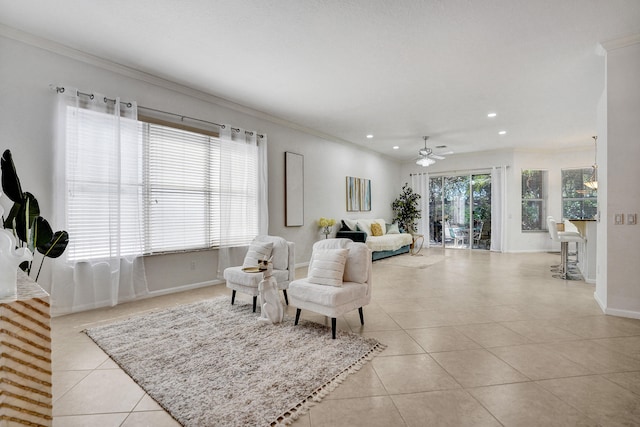 tiled living room with ceiling fan and ornamental molding