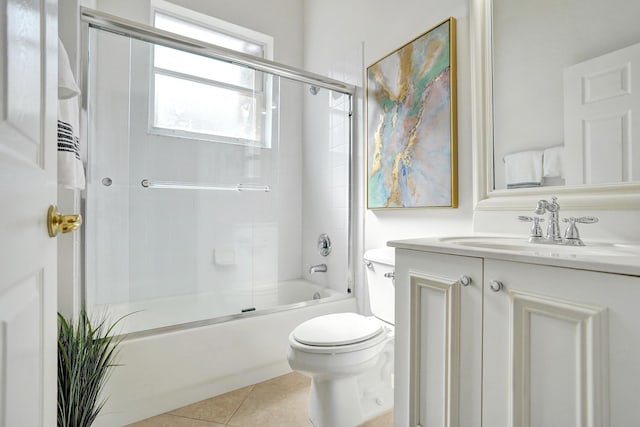 full bathroom featuring tile patterned flooring, vanity, shower / bath combination with glass door, and toilet