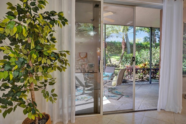 doorway with expansive windows and tile patterned floors