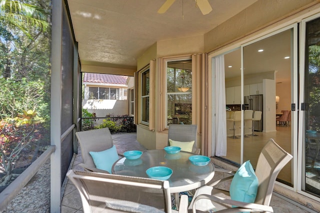 sunroom with ceiling fan