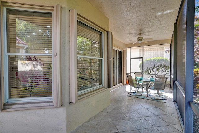 sunroom featuring ceiling fan