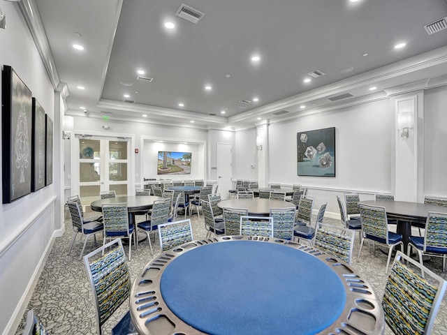 dining space featuring crown molding and a raised ceiling