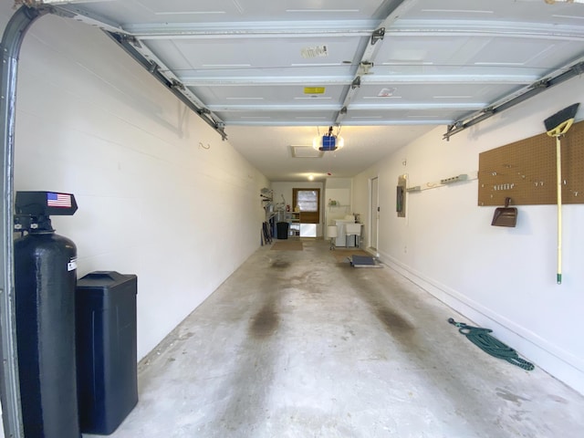 garage with a garage door opener and electric panel