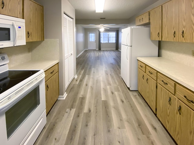 kitchen with white appliances, ceiling fan, a textured ceiling, decorative backsplash, and light wood-type flooring