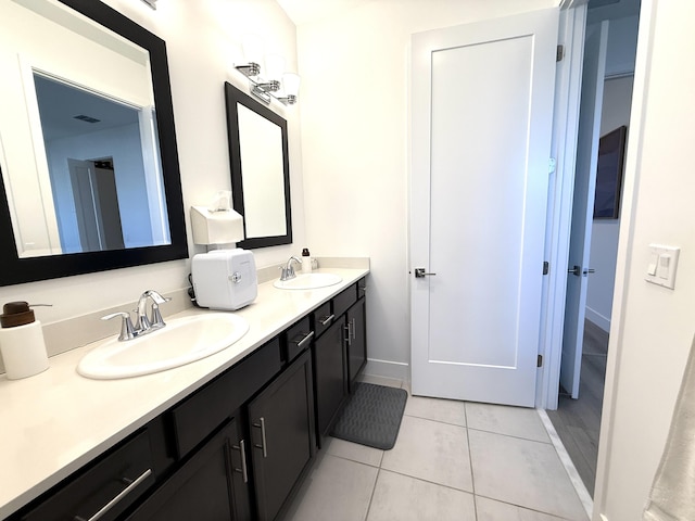 bathroom featuring tile patterned flooring and vanity