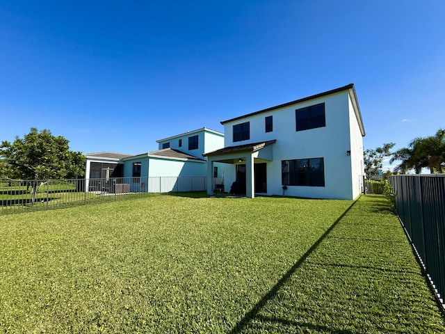 back of house featuring a yard