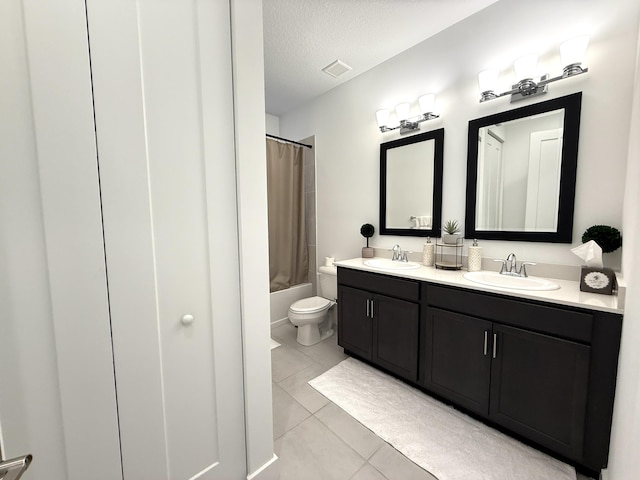 full bathroom with shower / tub combo, vanity, a textured ceiling, tile patterned floors, and toilet