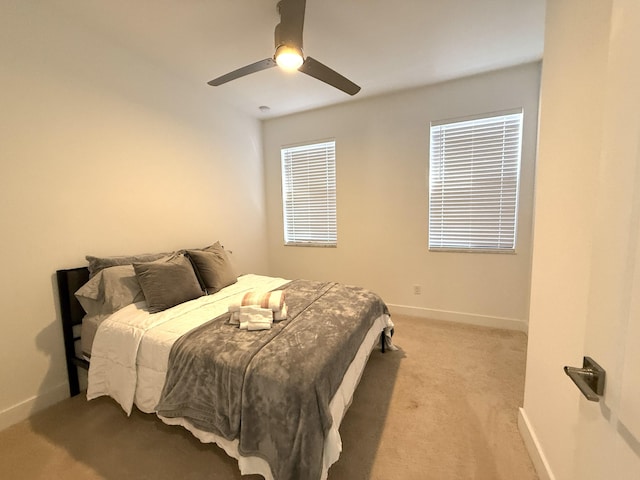 bedroom featuring light carpet and ceiling fan