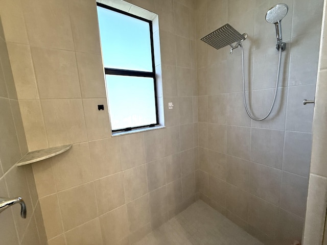 bathroom with a tile shower