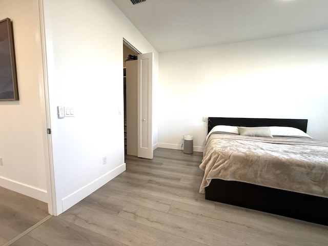 bedroom with wood-type flooring