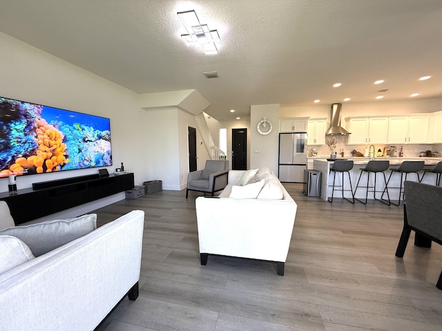 living room featuring hardwood / wood-style flooring and a textured ceiling