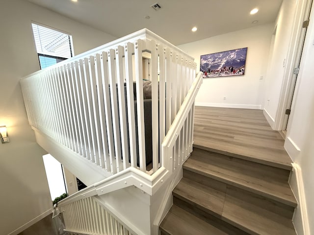 stairs featuring hardwood / wood-style flooring