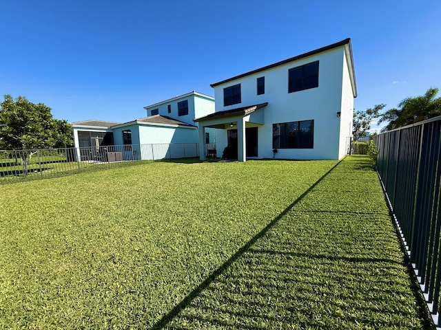 back of house featuring a yard