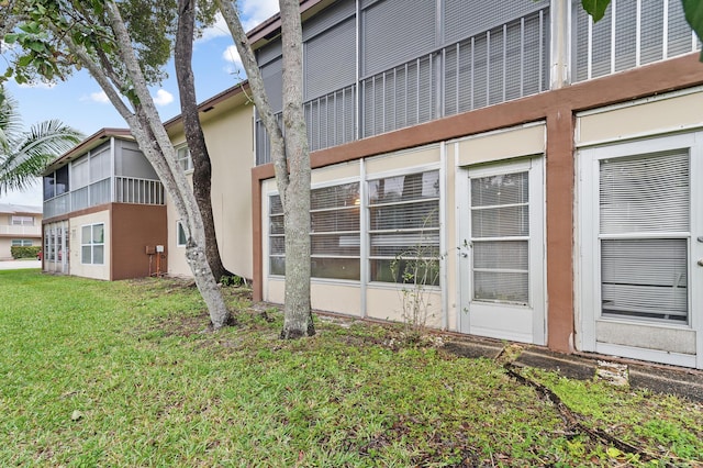 view of side of home with a yard