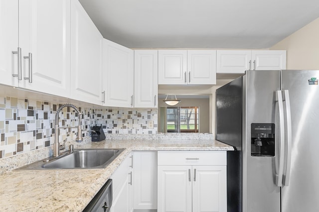 kitchen featuring white cabinetry, sink, tasteful backsplash, and stainless steel appliances