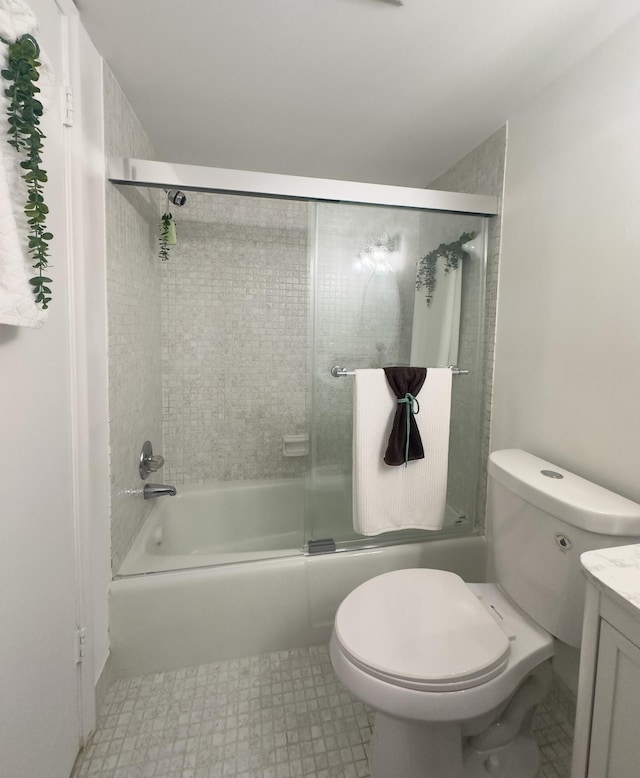 full bathroom featuring vanity, toilet, and combined bath / shower with glass door