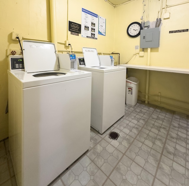 clothes washing area with washer and dryer and electric panel