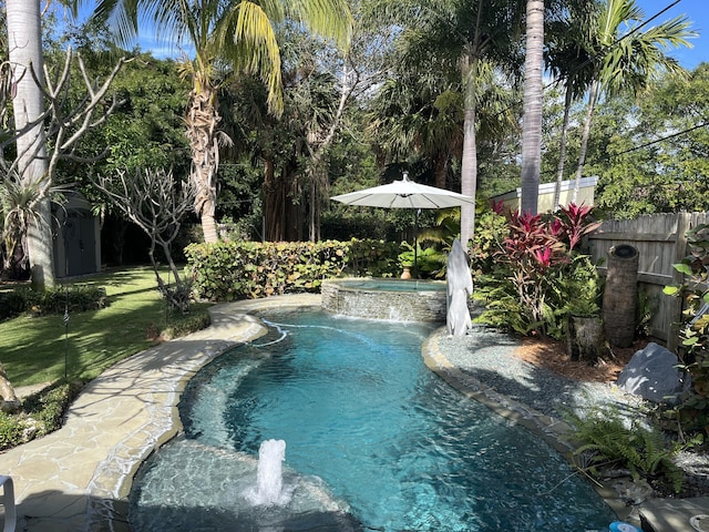 view of swimming pool with an in ground hot tub and pool water feature