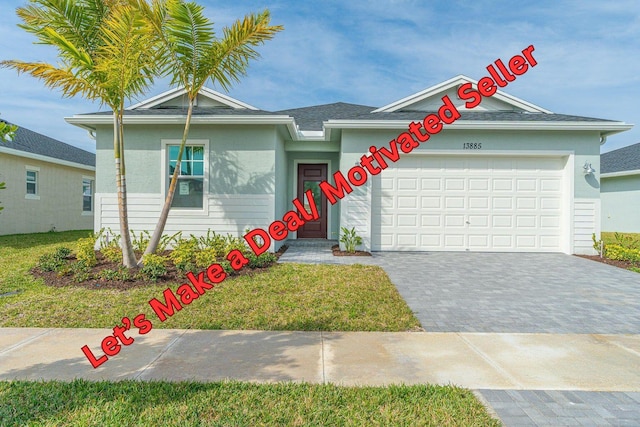 ranch-style home with decorative driveway and an attached garage