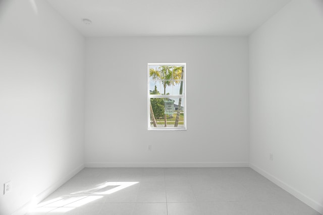 unfurnished room featuring light tile patterned floors