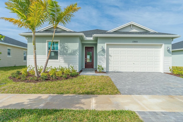 ranch-style home with a front yard, decorative driveway, a garage, and stucco siding