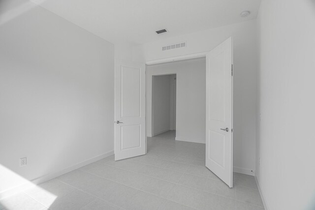 full bathroom with tiled shower / bath, vanity, toilet, and tile patterned flooring