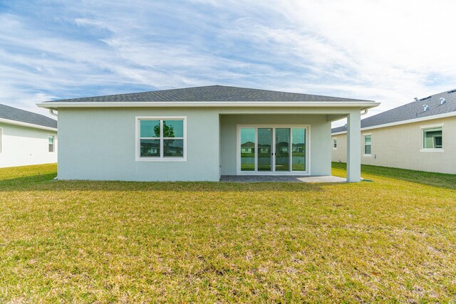 rear view of house with a lawn