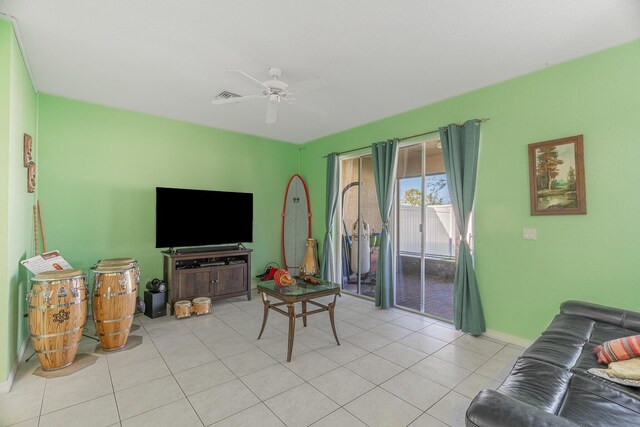 living room featuring light tile patterned flooring and ceiling fan