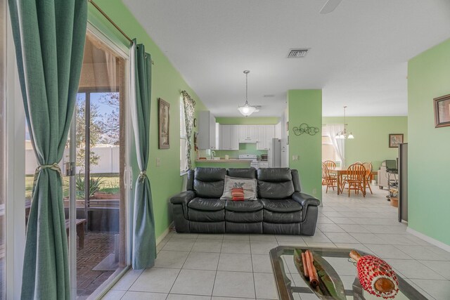 bedroom with ceiling fan, a tray ceiling, and light wood-type flooring