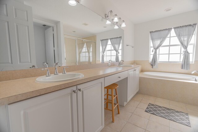 bathroom featuring vanity and independent shower and bath