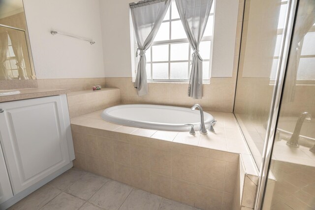 bathroom featuring tile patterned floors, shower with separate bathtub, and toilet