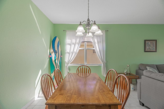 tiled dining room featuring a notable chandelier