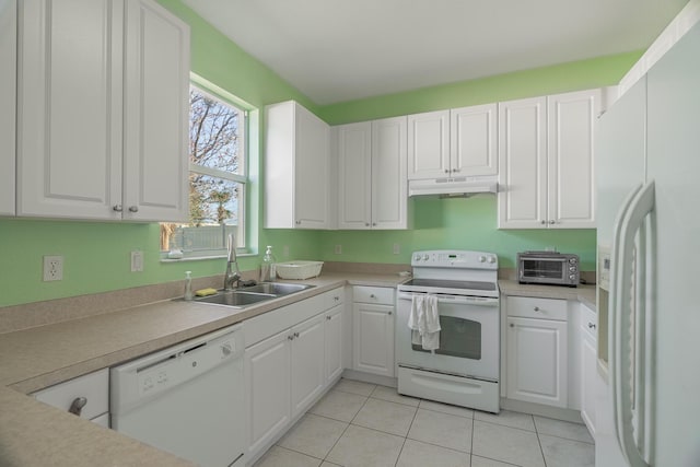 kitchen with white appliances, light tile patterned floors, sink, and white cabinets