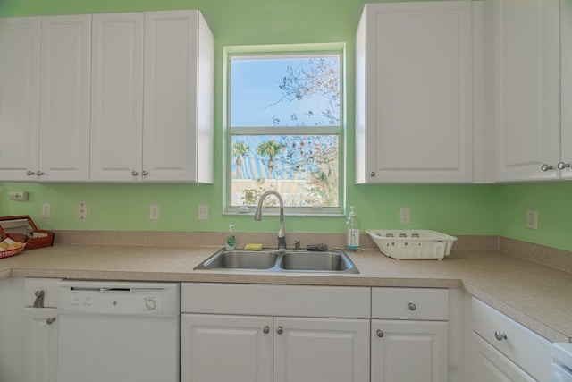 kitchen featuring dishwasher, sink, and white cabinets