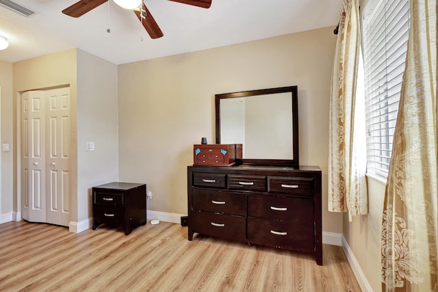 bedroom with ceiling fan, a closet, and light wood-type flooring