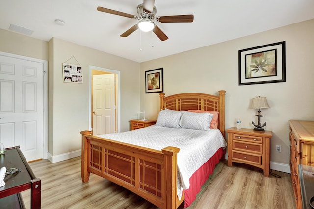 bedroom with light hardwood / wood-style flooring and ceiling fan