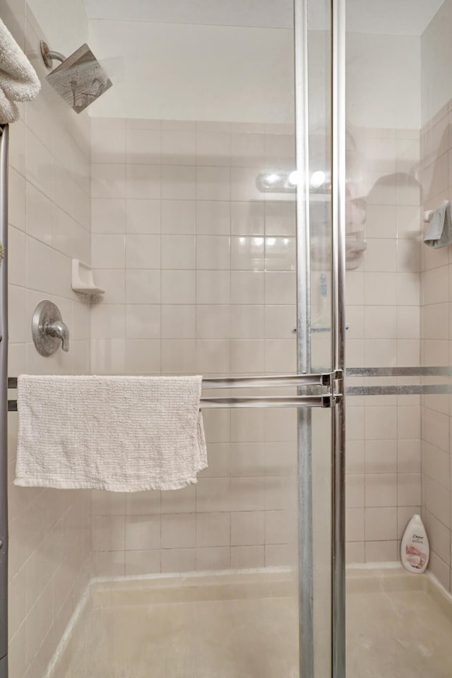 bathroom featuring a shower with door